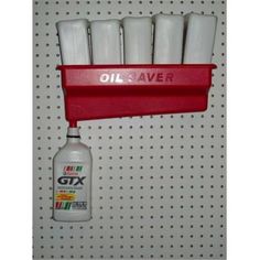 oil saver and bottles hanging on a wall in a store or office area with pegs to hold them