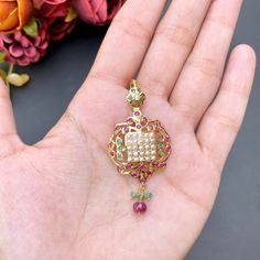 Featuring a 22ct gold pendant set that has been embellished with rubies, emeralds and pearls. The pendant set weighs 10.57 GMs including 0.86 GMs in hanging beads. Price Breakup Summary Component Rupees % of Total 22k Gold 45,640 74.0% Stones & Beads 6,014 9.8% Making Charges 8,215 13.3% Taxes (GST) 1,796 3.0% Total 61,666 100.0% View Detailed Price Breakup 22k Gold Jewelry Necklaces, Hanging Beads, 22k Gold Jewelry, Pearl Necklace Set, Gold Jewelry Necklace, Emerald Necklace, Gold Bangle Bracelet, 22k Gold, White Silver