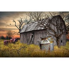 an old barn sits in the middle of a field with trees and birds flying overhead