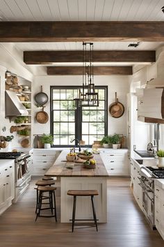 a large kitchen with white cabinets and wooden counter tops, along with two stools in front of the island