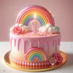 a birthday cake decorated with pink icing, rainbow and flowers on a gold platter