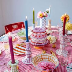 a table topped with lots of different types of cakes and glasses on top of it