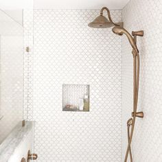 a bathroom with a shower head and hand held shower faucet in the corner