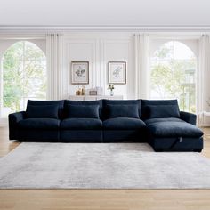 a living room with large windows and a blue couch in front of a white rug