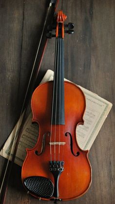 an old violin is sitting on the floor