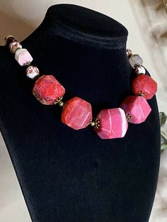 Necklace Length: 45.5+7cm (18+2.75in)*Weight: 133g Bracelet Length: 18.5+4cm (7.25+1.5in)* Weight: 26g Earrings Length: 33mm Weight: 6g Necklace “Wild Roses” - Porcelain Beads, Garnet, Pink Agate Raw Faceted Beads (biggest 26x26mm), Mother of Pearl, Brass Accessories.Pink Agate- a symbol of good luck. It is believed that the longer you wear pink agate, the better it works.Garnet- the stone with the most powerful energy. Helps to achieve goals and not lose enthusiasm. Needed by every traveler, bu Pink Faceted Beads Jewelry, Red Faceted Spiritual Jewelry, Pink Jewelry With Faceted Round Beads, Pink Round Gemstone Beads Jewelry, Pink Round Jewelry With Gemstone Beads, Adjustable Faceted Agate Jewelry, Pink Round Gemstone Beaded Jewelry, Round Pink Jewelry With Gemstone Beads, Pink Spiritual Jewelry With Faceted Beads