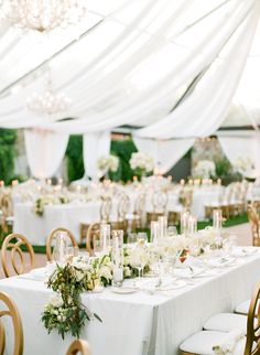 the tables are set with white linens and gold chairs for an elegant wedding reception