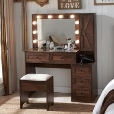 a vanity with lights on it and a stool