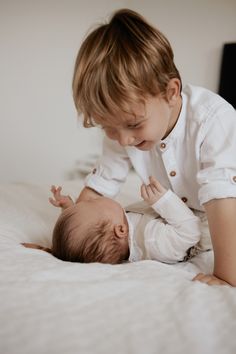 a young boy is playing with his baby