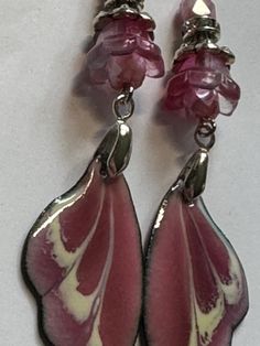 Handmade OOAK dangle earrings made with ARTISAN ENAMELED WINGS CHARMS by Sabrina Designs, a Lampwork bead artist. I also used Czech glass and glass beads and silver metal findings to complete these earrings. They are about 2.75" dangle. Pink Enamel Dangle Jewelry, Handmade Pink Glass Jewelry, Pink Metal Clip-on Earrings For Gift, Pink Metal Clip-on Earrings As A Gift, Artistic Resin Dangle Jewelry, Hand Painted Sterling Silver Dangle Jewelry, Artistic Czech Glass Jewelry With Ear Wire, Pink Teardrop Beads For Jewelry Crafting, Pink Teardrop Jewelry Beads For Crafting