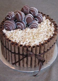 a cake with chocolates and marshmallows in the shape of a heart