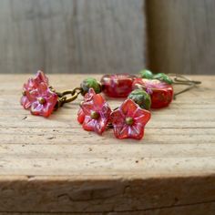 So excited to show off these new beads. I happen to see these sitting together and knew they needed to stay together! The beautiful little bell flower beads are 5x8mm, translucent red orange pink base, coated in light golden Picasso and pink metallic wash. So beautiful! They are complimented by another new bead. It is a 12mm, hibiscus flower bead in a mix of pink glass, with deep orange striations. They are finished with golden metallic luster and pink wash remaining in the recessed grooves. The Nickel-free Czech Glass Flower Earrings, Beaded Czech Glass Flower Earrings Gift, Beaded Flower Earrings With Czech Glass For Gifts, Adjustable Flower Earrings With Dangling Beads For Gifts, Flower Drop Earrings With Dangling Beads For Gifts, Gift Beaded Flower Earrings With Czech Glass, Czech Glass Dangle Flower Earrings As Gift, Gift Flower Earrings With Beaded Czech Glass, Flower Charm Round Bead Earrings For Gifts