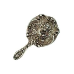 a silver spoon with an ornate design on it