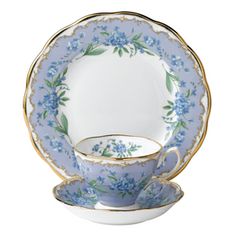 a blue and white china tea set with flowers on the rim, saucer and cup