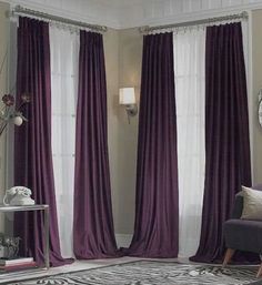 a living room with purple drapes and zebra rug