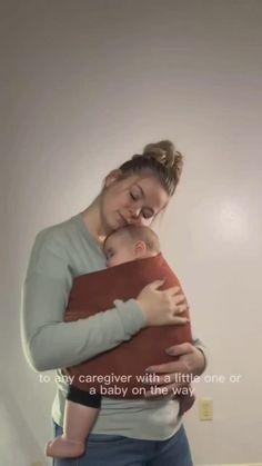 a woman holding a baby in her arms