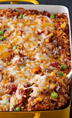 a casserole dish with meat, rice and vegetables in it on a table