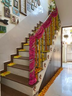 the stairs are decorated with garlands and flowers on each side, along with decorations