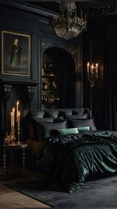 a bedroom with black walls and dark bedding, chandelier and candles in the corner