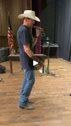 a man in a cowboy hat standing on a stage