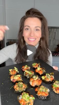 a woman is holding up some food in front of her