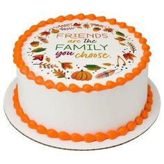 a white cake with orange frosting and an inscription on the top that says friends are family you choose