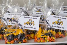 small bags filled with candy sitting on top of a table next to construction themed candies