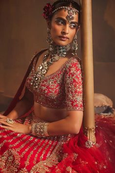 Red attached cancan lehenga with zardozi, thread, sequin embroidery in floral pattern. Paired with half sleeve padded blouse and scallop border embroidered dupatta.
Components: 3
Pattern: Embroidery
Type Of Work: Zardozi, thread, sequin
Neckline: Leaf neck
Sleeve Type: Half sleeves
Fabric: Raw Silk
Color: Red
Other Details: 
Lehenga:
Attached cancan
Floral pattern
Length: Approx 43 - 44 inches
Blouse:
Padded
Dupatta:
Embroidered borders
Semi sheer
Note: All the jewellery worn by the model is not Red Festive Tilla Sharara, Red Sets With Tilla In Traditional Drape, Red Sets With Tilla Detail And Traditional Drape, Red Fitted Sharara With Tilla, Fitted Red Sharara With Tilla Details, Red Fitted Embellished Sharara, Red Tilla Choli For Navratri, Red Bollywood Choli With Tilla Detail, Bollywood Style Red Choli With Tilla Details