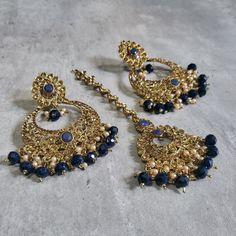 This listing is for Indian style Navy blue earrings and Maang Tikka set. These stunning earrings are crafted to enhance your style, whether you're attending a party or a wedding ceremony. They are guaranteed to make you stand out in the crowd. Elevate your style with these stunning dark blue earrings tika set. Make a bold fashion statement and turn heads wherever you go. Shop my stunning collection today! In addition to these earrings, I offer various hand-crafted Indian and Pakistani jewelry st Blue Metal Jewelry For Festivals, Blue Hand Set Round Earrings, Hand Set Round Blue Earrings, Elegant Hand Set Chandbalis For Party, Elegant Party Chandbalis With Hand Set, Elegant Party Chandbalis With Hand Set Details, Elegant Party Tikka With Hand Set Details, Hand Set Danglers For Party And Festive Occasions, Hand Set Danglers For Party And Festive Season