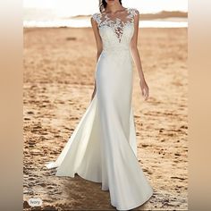 a woman in a wedding dress on the beach