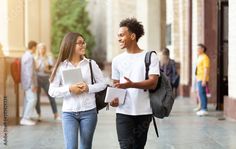 two students walking down the street talking