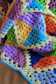 a colorful crocheted blanket on top of a chair