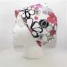 a white mannequin head wearing a pink and black floral print hat on it's head