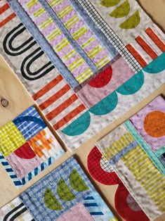 quilts laid out on top of each other with different patterns and colors in them