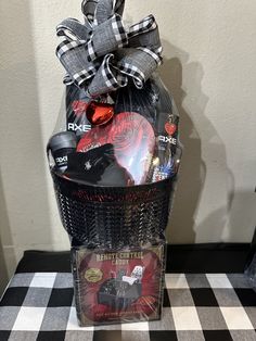 a gift basket filled with items on top of a checkered table cloth