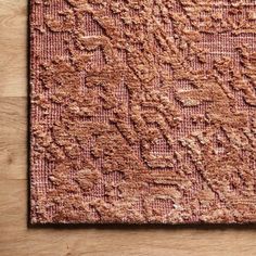 a brown rug on top of a wooden floor