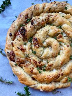 an overhead view of a pastry with herbs on it