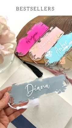 a person holding up some paint with the words diana on it in front of them