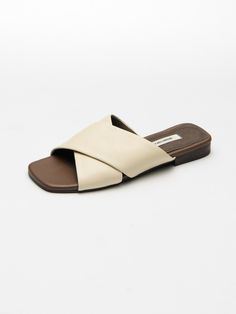 Editor's NotesSEONG YUN JOO is a designer brand specializing in flat shoes with the concept of basic & classic.- Slide styled slippers- Square lined open toe- Criss cross designed strap- Stable fit with wide strap- Comfortable fit with sheepskinMeasurements(in.)KR size- Size: 215MM (US 4.5) - 265MM (US 9.5)- Heel height: 0.55 in.*Fits true to the sizeComposition & Care- Shell: Sheepskin  Cow Leather / Lining: Pigskin / Outsole: Synthetic Rubber- Avoid direct heat and moisture- Keep in a Classic Open Toe Flats With Removable Insole, Classic Open Toe Flats With Leather Sole, Classic Flat Slippers For Summer, Classic Cream Sandals With Leather Sole, Classic Slip-on Sandals With Flat Heel, Classic Summer Slip-on Slippers, Classic Flat Slides For Spring, Classic Open Toe Mules With Rubber Sole, Classic Spring Slippers With Rubber Sole