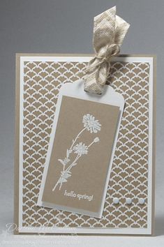 a card with a tag and some flowers on it