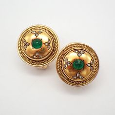 Vintage 20k (.833) yellow gold round form earrings, decorated with Emerald cabochons and accented with Diamonds, featuring foliate pattern. The earrings were tested with an XRF machine, resulting 20k yellow gold with 14k yellow gold omega clasps. The clasps were soldered on as a replacement and display some minor discoloration (please see pictures). These spectacular earrings are 19 mm in diameter, weighing a total 13.8 grams.  The Emeralds are 4.5 mm in diameter, and 24 rose-cut Diamonds are 1.3 mm in diameter each. EA3487 Gold Cabochon Earrings For Anniversary, Luxury Round Cabochon Clip-on Earrings, Gold Vintage Cabochons, Elegant Yellow Gold Cabochons For Wedding, Classic Gold Cabochon Earrings, Vintage 22k Yellow Gold Earrings, Luxury Round Jeweled Earrings, Luxury Jeweled Round Earrings, Traditional Yellow Gold Clip-on Earrings For Formal Occasions