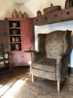 an old chair sitting in front of a book shelf