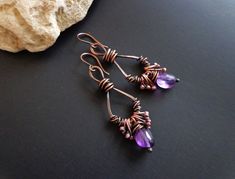 Raw stone earrings. Raw Amethyst earrings. Rustic earrings. Copper earrings. Wire wrapped earring. Gemstone earrings. Unique earrings. Artisan earrings. These earrings are made from pure copper wire. They are hand-shaped, hammered and wax polished. ● Materials: Natural stone, Copper ● Measures: - Length- about - 2.36 inches (6 cm) x 0.71 inches (1.8 cm). All my jewelry is my own original design and handcrafted by me. The color and brightness of the product in the photograph depending on the sett Purple Stone Earrings, Nugget Earrings, Raw Stone Earring, Rustic Earrings, Earrings Wire, Wrapped Earrings, Earrings Purple, Raw Amethyst, Artisan Earrings