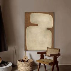 a room with a chair, lamp and painting on the wall