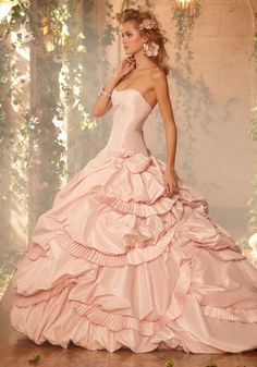 a woman in a wedding dress is standing on a wooden floor next to a window