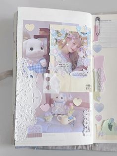 an open scrapbook with pictures and stickers on the pages, including a teddy bear