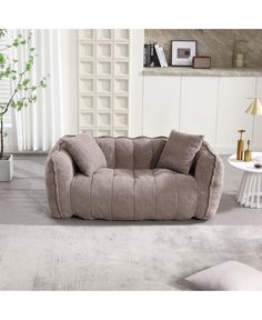 a living room scene with focus on the couch and rugs in the foreground