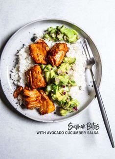 a white plate topped with chicken and broccoli covered in sauce next to rice