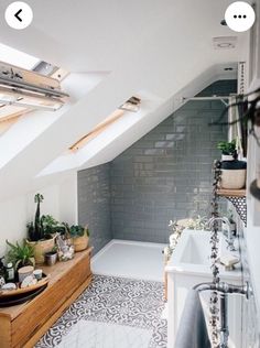 an attic bathroom with tiled floors and skylights above the bathtub is shown in this image