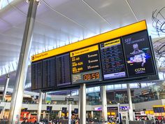 an airport terminal with many electronic displays